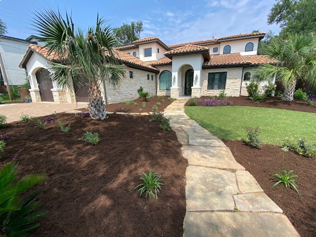 Flagstone and natural stone walkway through Austin garden