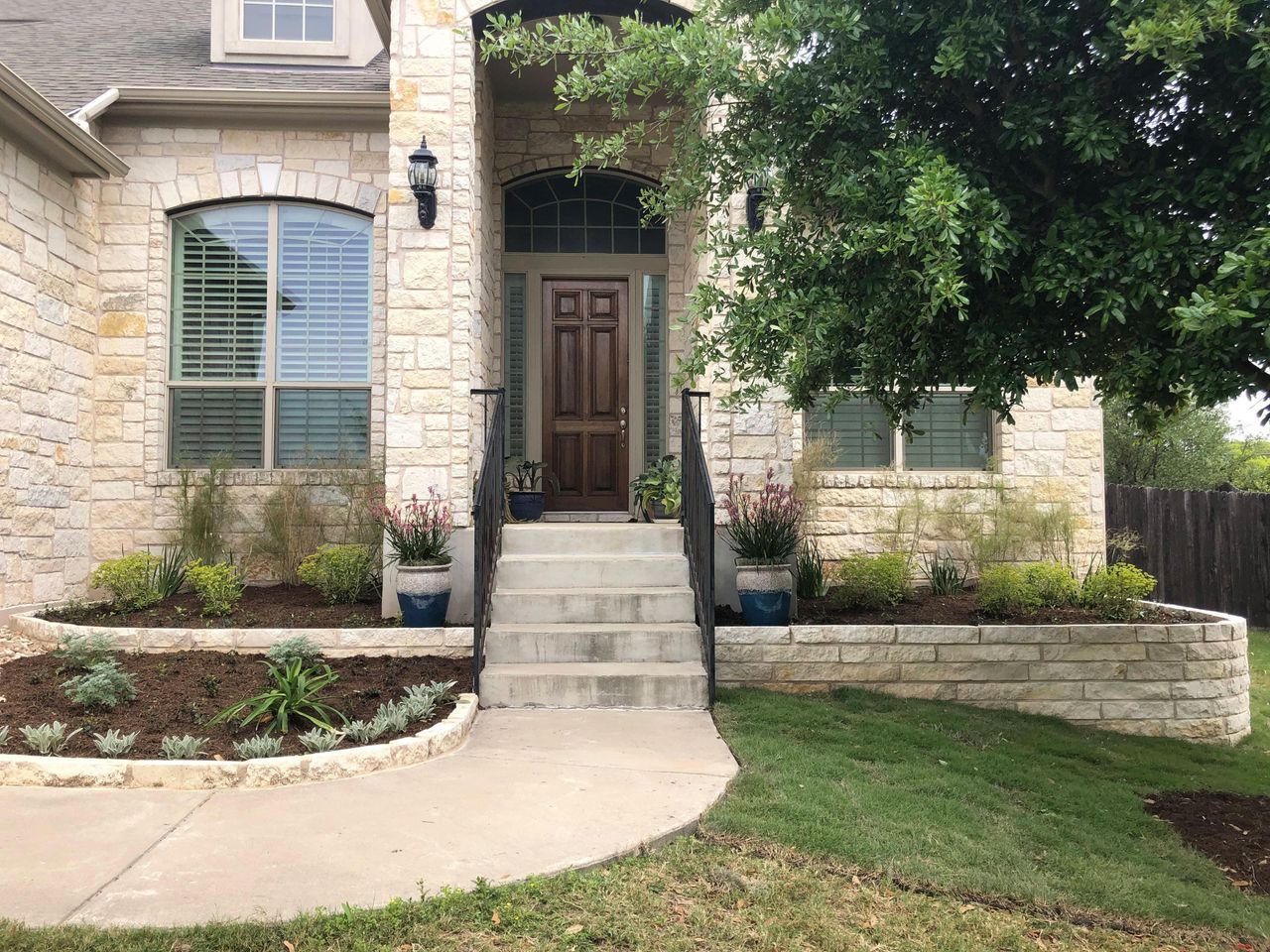 Shrub planting and screening installed along an Austin property border