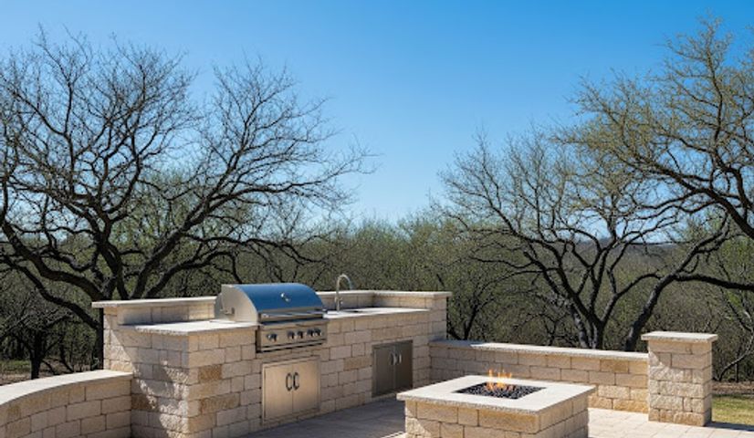 Outdoor kitchen and fire pit area with pavers in Austin TX