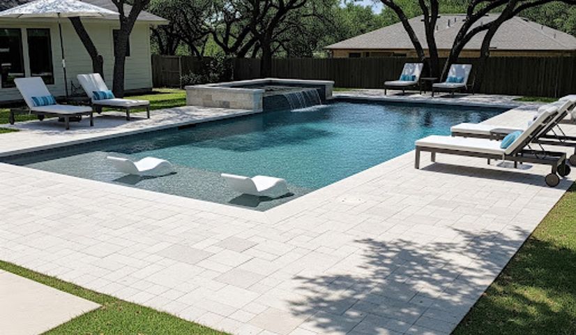 Paver pool deck surrounding a backyard pool in Austin TX