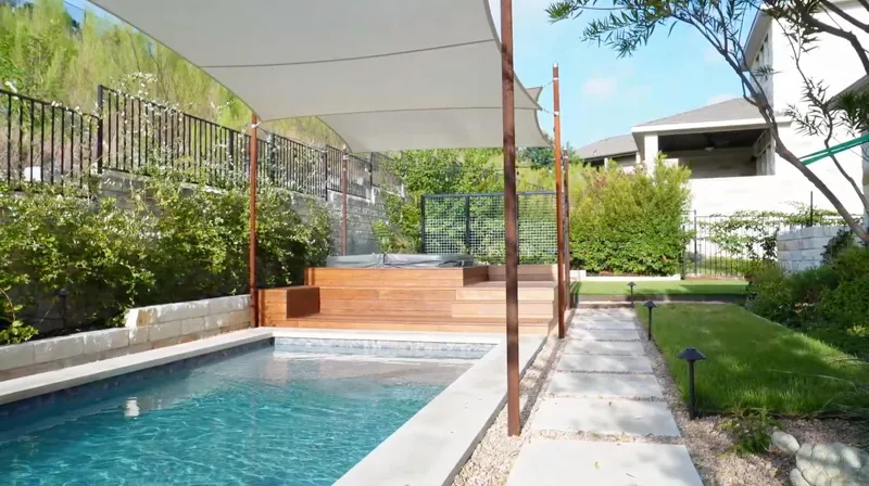 Poolside hot tub deck, shade sails, planting, and a path at the Balvadino Skyway project